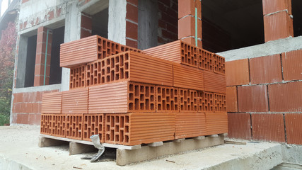 Several red perforated brick on pallet