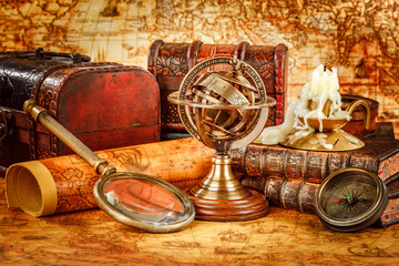 Vintage magnifying glass lies on an ancient world map