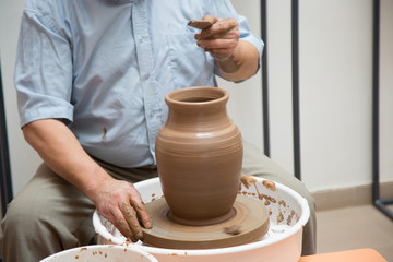 Fototapeta na wymiar potter working on ceramic jug