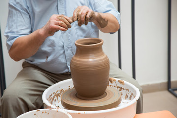 potter working on ceramic jug