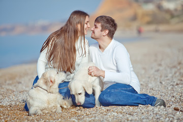 happy family on the beach with labradors