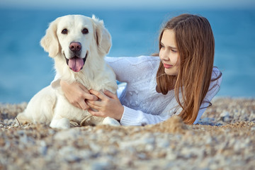 happy kid with her dog friend labrador