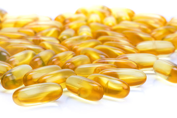 capsules with fish oil on a white surface