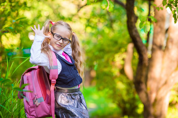 Adorable school girl backpack notes outdoor. Back to school.