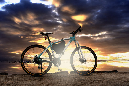 Mountain bike with sunset sky and sea