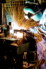 MIG welder uses torch to make sparks during manufacture of metal equipment.