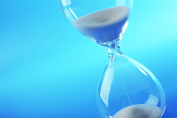 Hourglass on blue background