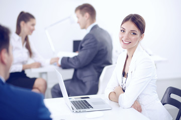 Fototapeta premium Beautiful young business people with colleagues discussing in