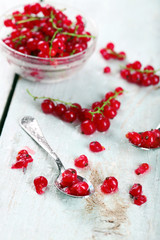 Fresh red currants on wooden table close up