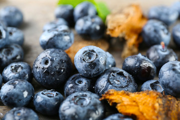 Tasty ripe blueberries on wooden table close up