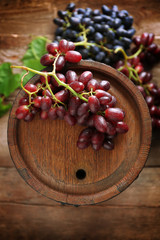 Old wine barrel and grape on wooden background