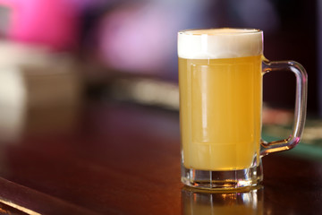 Cold beer glass on bar or pub desk