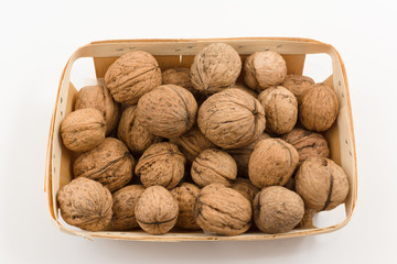 wooden container is filled with a walnut on a white background