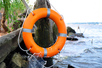 A life buoy hanging on the bench on beautiful sea view