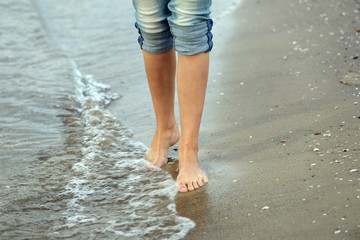 Woman walking on sand beach