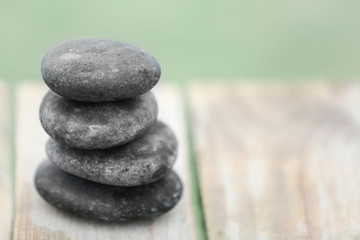 Pebbles on wooden background