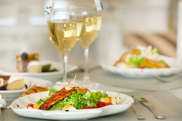 Tasty salad with served wine