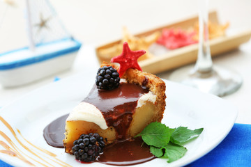 Delicious cake under chocolate glaze with blackberry