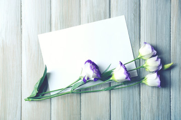 Composition of white sheet and  blossom on grey wooden background, empty space