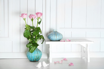 Home decor and roses on wooden background