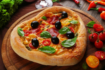 Heart shaped pizza served on wooden table, closeup