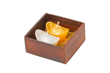 Artificial wedding souvenir candles in wooden box isolated on wh