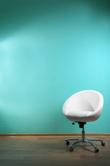 White chair on blue wall background