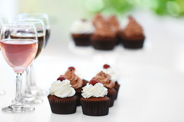 Tasting of wine and chocolate cupcakes, close up