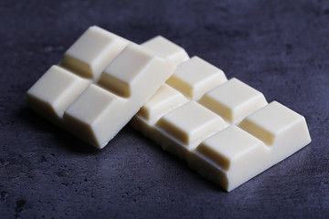 White chocolate pieces on gray background