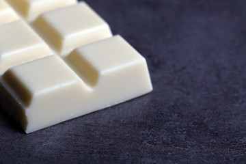 White chocolate pieces on gray background