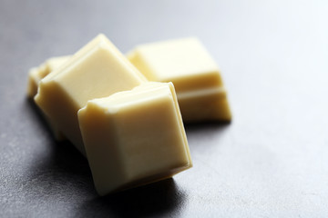 White chocolate pieces on gray background