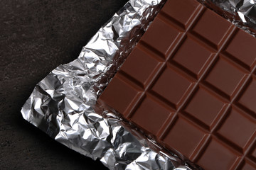 Chocolate bar in foil  on gray background