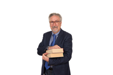 Senior teacher standing holding many books, looking happy, isola