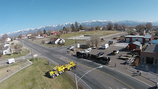 Aerial semi truck and trailer roll over accident rural town HD 0031