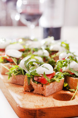 Tomato, mozzarella and arugula sandwich