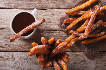 churros and hot chocolate close-up on the table. horizontal top view
