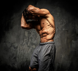 Shirtless muscular guy posing in studio.