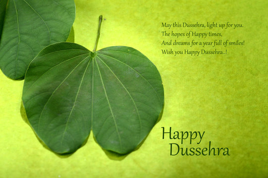 Indian Festival Dussehra, showing golden leaf on green background. Greeting card.