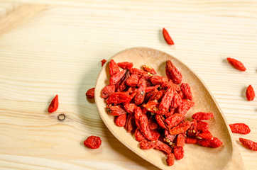 Dried goji berries on wooden tablespoon