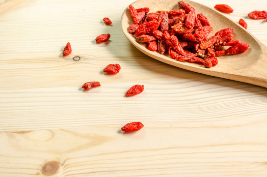 Dried goji berries on wooden tablespoon
