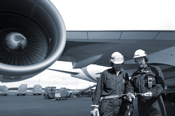 airplane mechanics with a giant jumbo jet engine