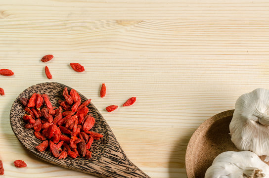 Dried goji berries on wooden tablespoon