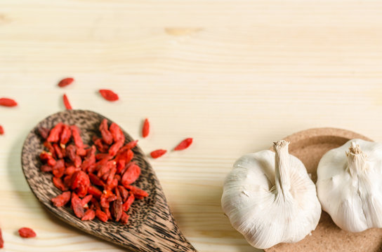 Dried goji berries on wooden tablespoon