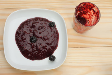 Blackberry jam on wooden table