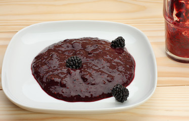 Blackberry jam on wooden table