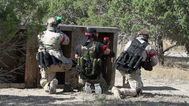 Paintball shooters behind protective barrier P HD 0118