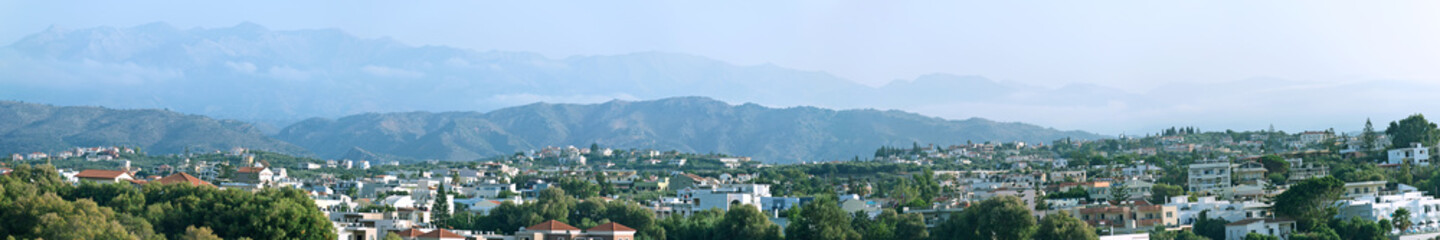 Panoramic view of the city and mountains.