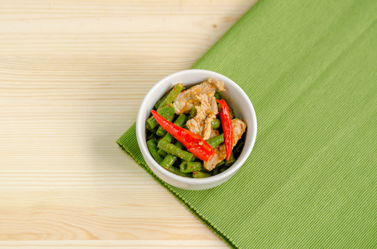 Spicy stir fried pork with red curry paste and Yard Long bean, T