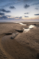 Stunning vibrant sunset landscape over Dunraven Bay in Wales