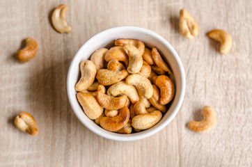Obraz na płótnie Canvas Close up cashew nuts on wooden background